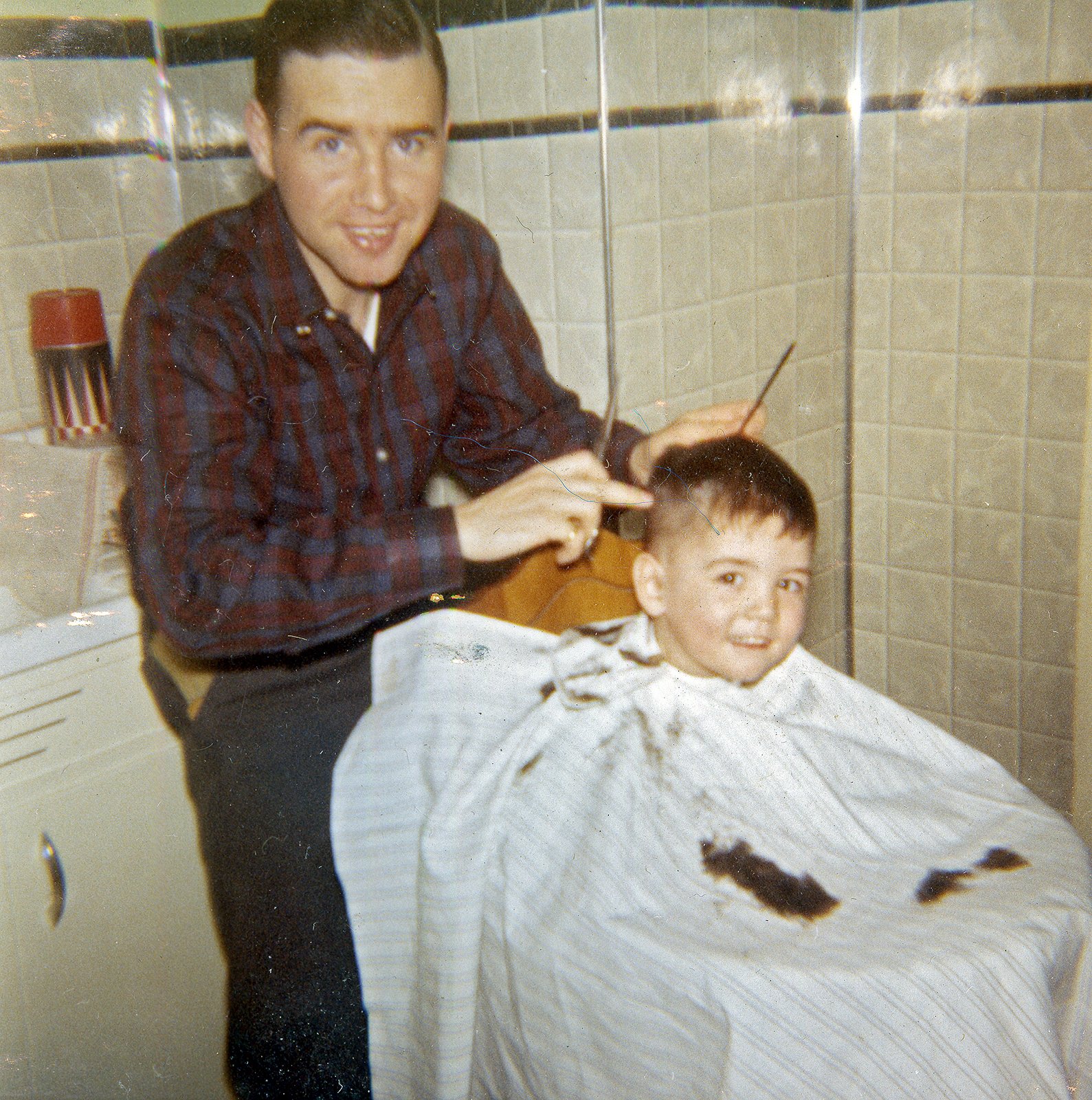 Seán Conlon getting a hair cut by Armagh native and family friend Frank Houlihan who worked as a professional barber in Philadelphia. Germantown, 1963.