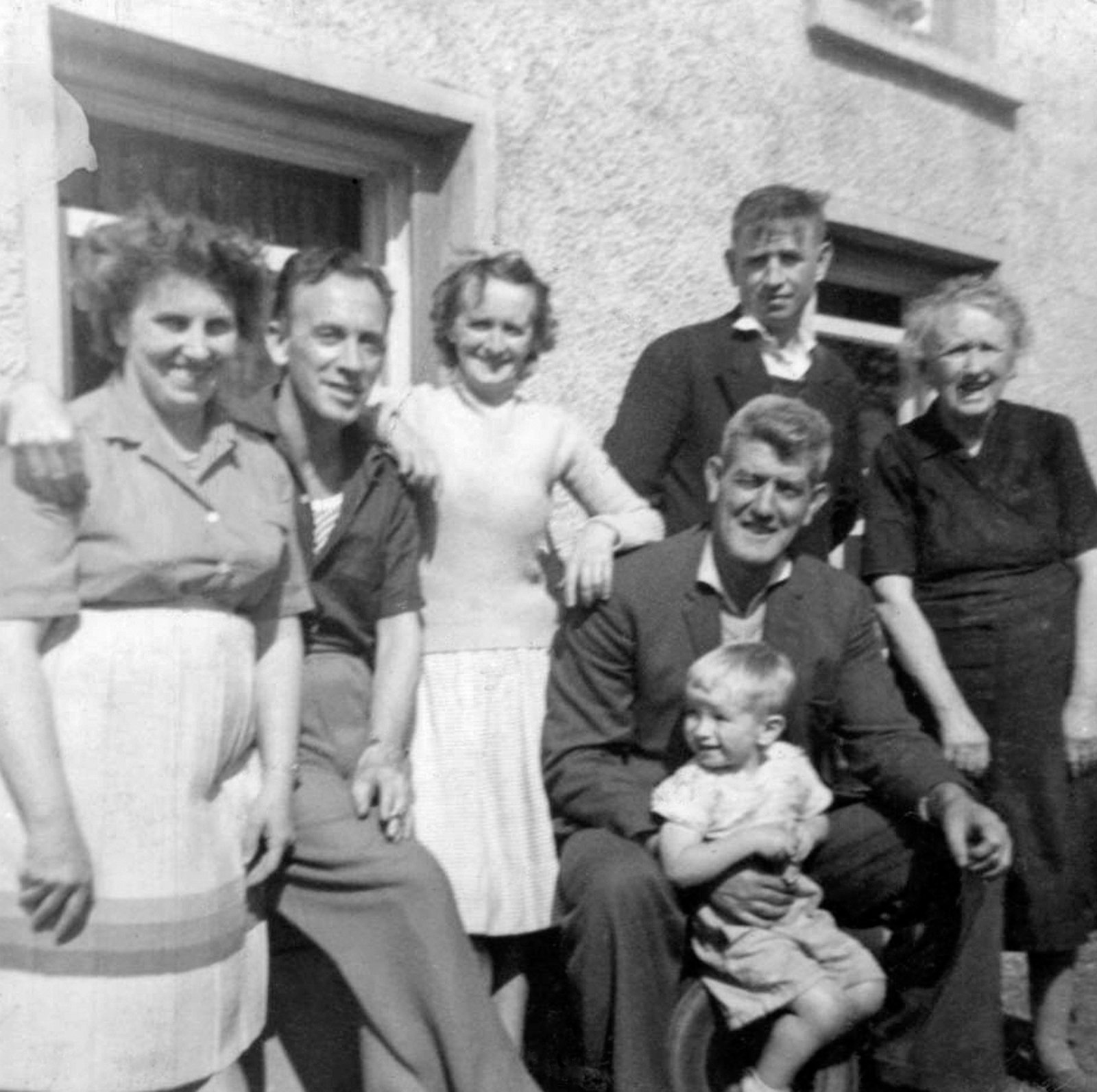 Aunt Molly and Uncle Paddy (visiting from London), Mum, Dad (holding Michael), Uncle Jim, and maternal grandmother outside her home in County Derry, 1961.