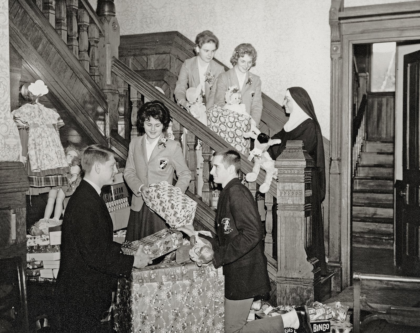 High school class working on a community service project. Moira Kennedy, then a high school senior, is on the stairs in the middle, c. 1962.