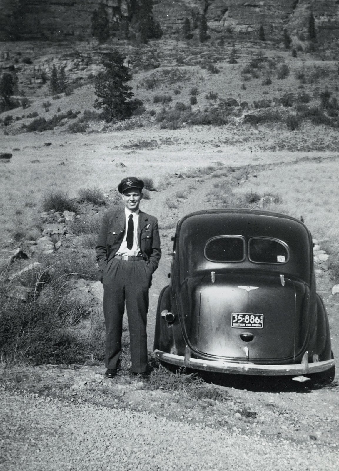Trevor Schubert in RCAF uniform beside car,Second World War.
